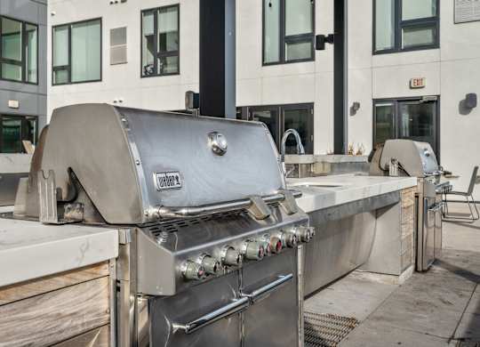 A large Volvo grill is on a patio.