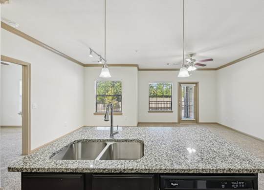 A kitchen with granite countertops and a sink.