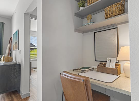 a home office with a desk and a window