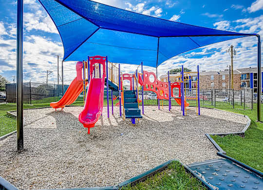 a playground with a swing set and slides