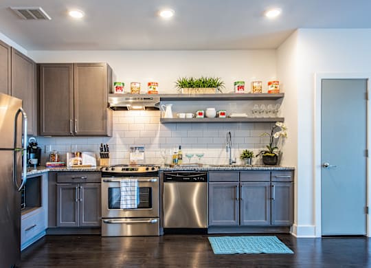 A modern kitchen with stainless steel appliances and wooden cabinets.