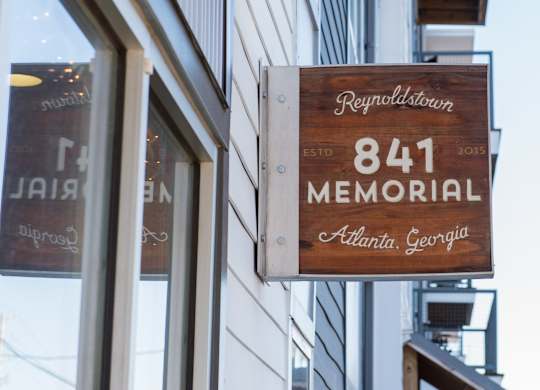 A sign for the 841 Memorial in Atlanta, Georgia is displayed on a building.