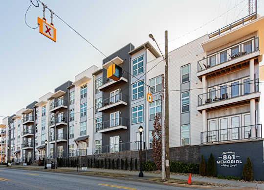 A street view of apartment buildings with a sign that reads "841 Memorial.".