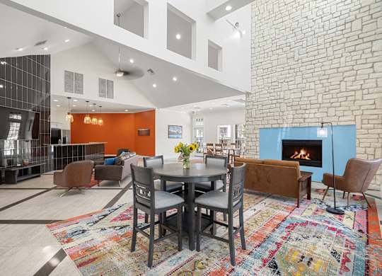 A modern living room with a brick wall and a fireplace.