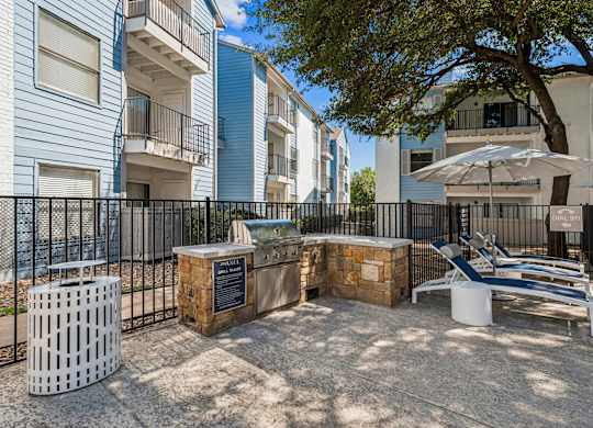 A sunny day at the outdoor seating area of a residential complex.