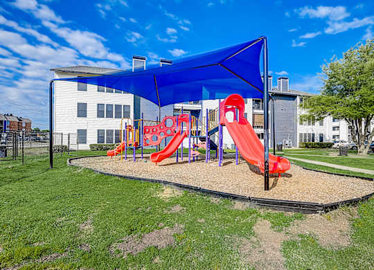 a playground with a blue canopy