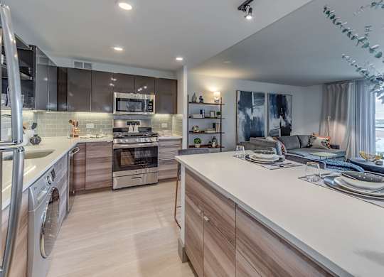A modern kitchen with stainless steel appliances and wooden cabinets.