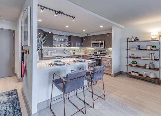A modern kitchen with a dining table and chairs.