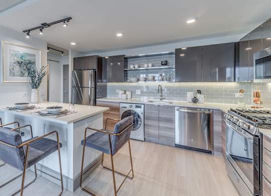 A modern kitchen with a dining table and chairs.