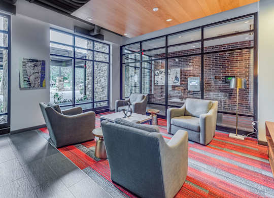 A room with a striped carpet and a glass wall.