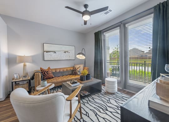 a living room with a couch and a ceiling fan