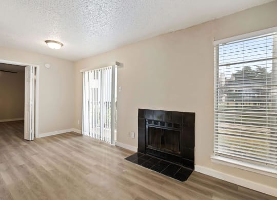 a living room with a fireplace and a large window