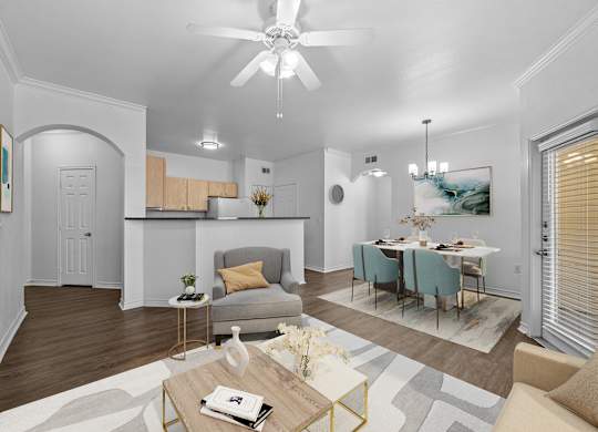a living room and dining room with a table and a ceiling fan