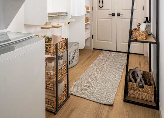 A white oven sits next to a white fridge in a small kitchen.