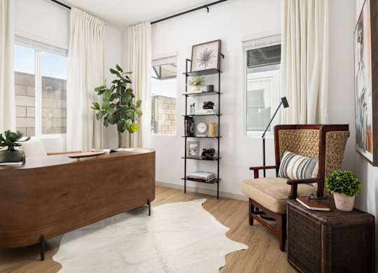 A bedroom with a large bed and a chair.
