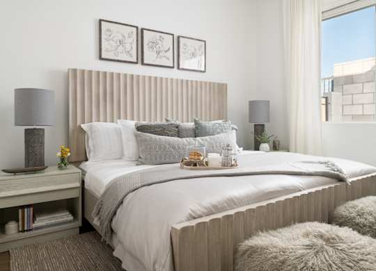 A bedroom with a large bed and a window.