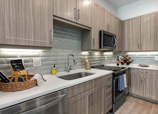 A modern kitchen with wooden cabinets and stainless steel appliances.