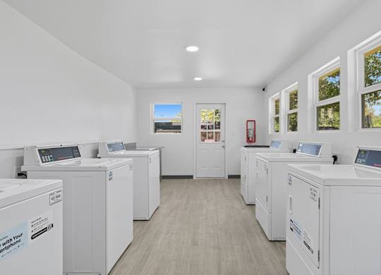 A row of washing machines in a laundromat.