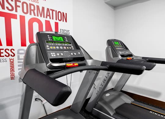 a close up of two treadmills in a gym