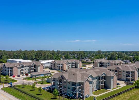 A large, well-maintained housing development with multiple buildings and green lawns.