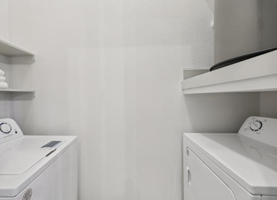 A white washing machine and dryer in a laundry room.