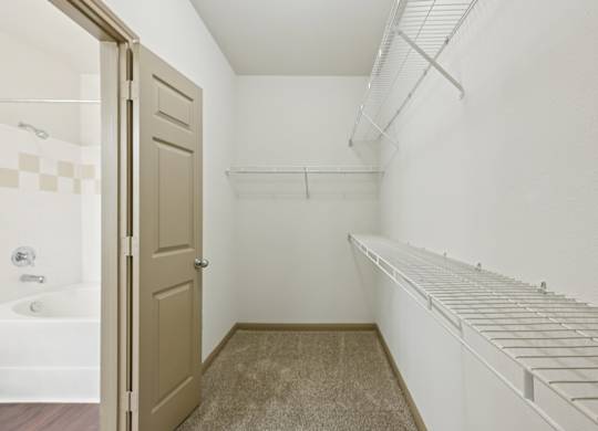 A white laundry room with a white washer and dryer.