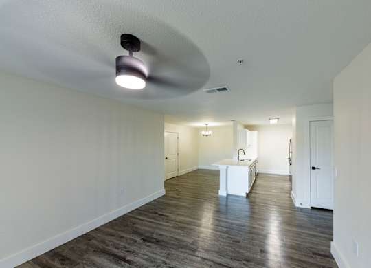 A spacious room with a white table and a light fixture on the ceiling.