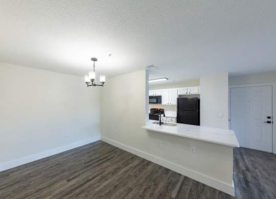 A kitchen area with a counter and a fridge.
