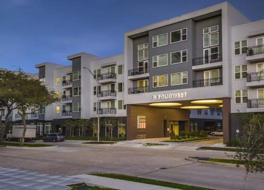 The image shows a modern apartment building named