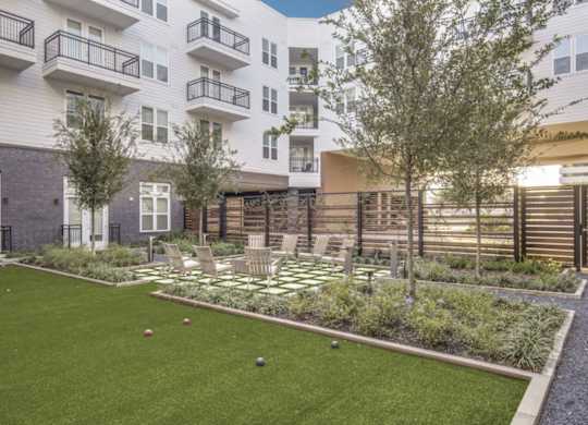A lawn with a checkerboard pattern in the middle of it.