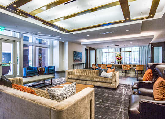 A spacious living room with a couch, chairs, and a coffee table.