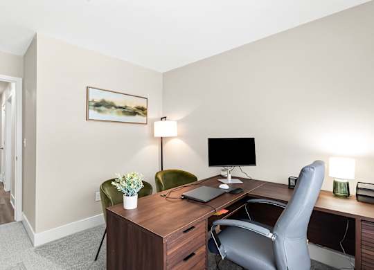 a room with a desk and a chair and a computer