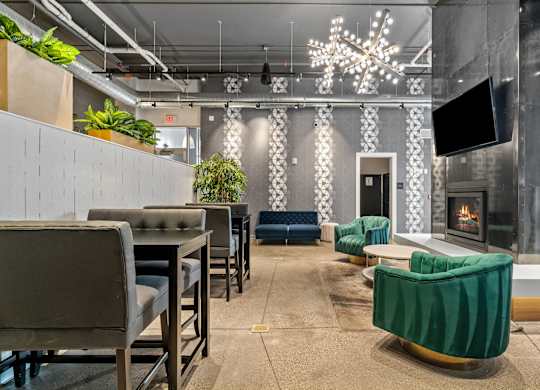 A modern lounge area with a fireplace and comfortable seating.