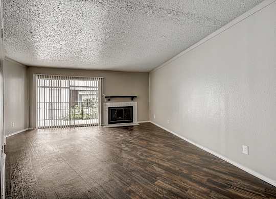 a living room with a fireplace and a large window