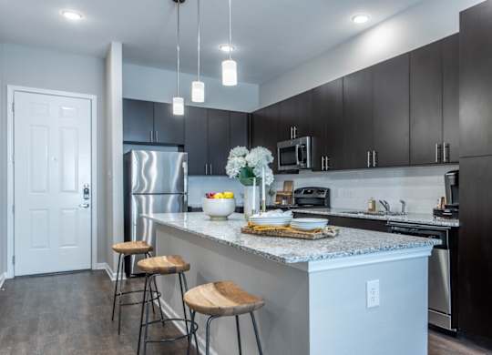 A kitchen with a white door and a white counter.