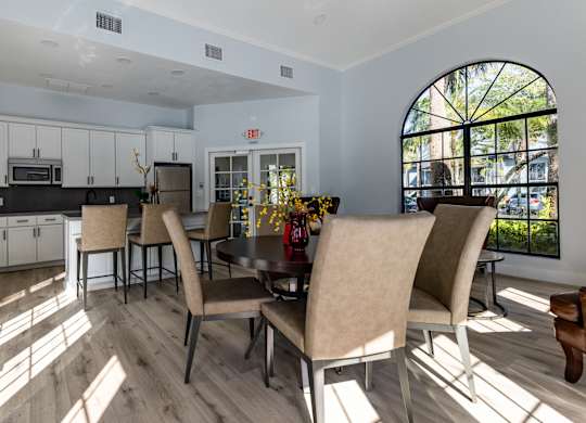A dining room with a table and chairs.
