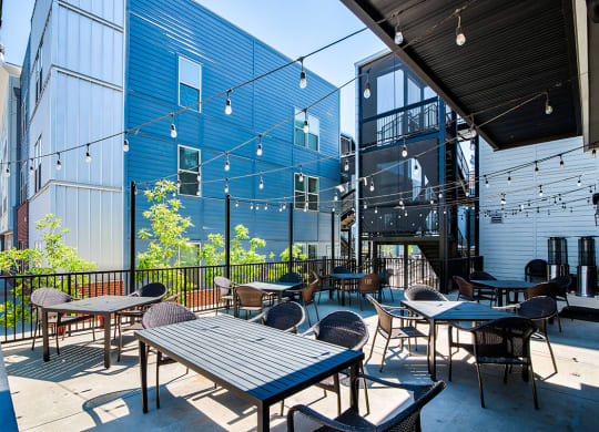 Community patio with tables and chairs on a sunny day