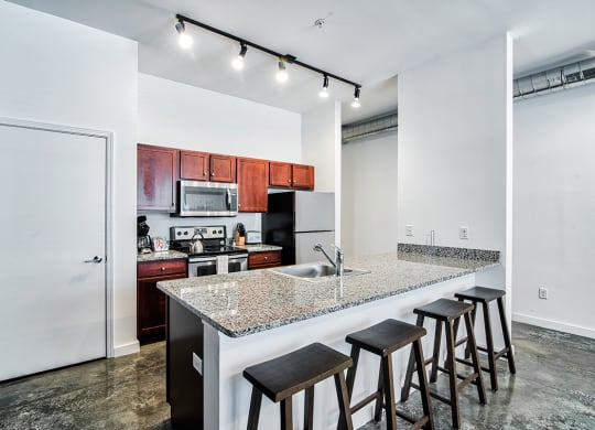 kitchen with an island with granite countertops