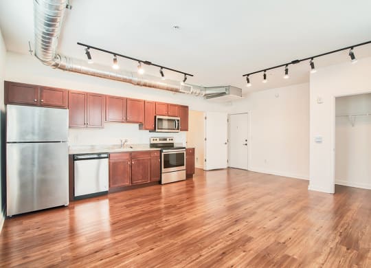 kitchen and living room with wood floors and white walls