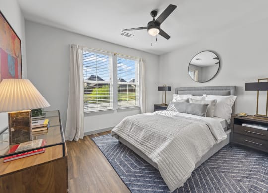 a bedroom with a bed and a ceiling fan