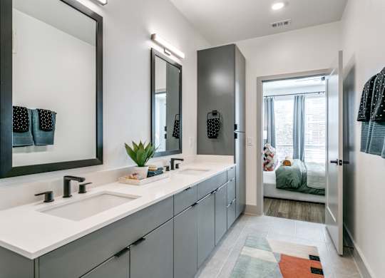 A bathroom with a white sink and a mirror above it.