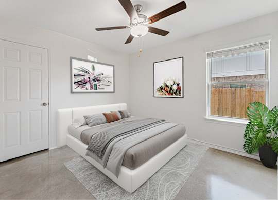 a bedroom with a bed and a ceiling fan