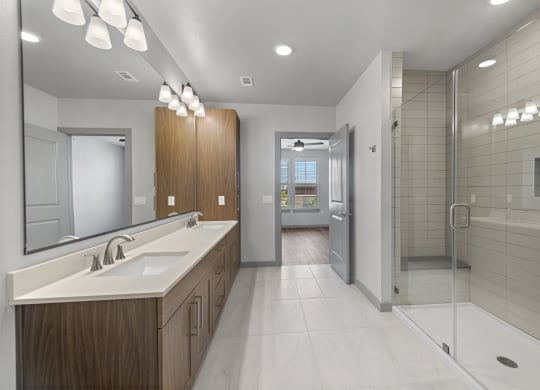 a bathroom with a shower and a sink and a mirror