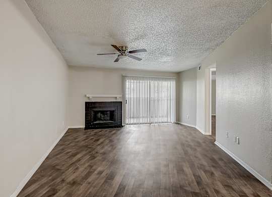 a living room with hardwood floors and a fireplace