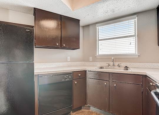 a kitchen with a dishwasher sink and refrigerator