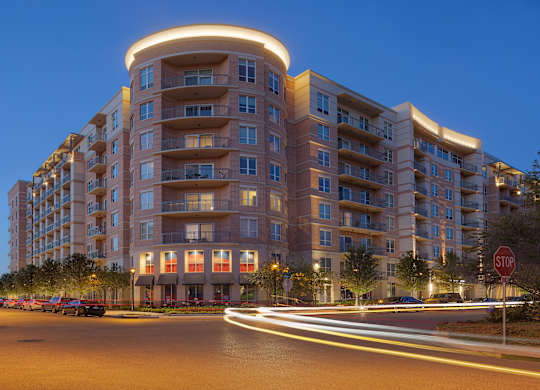 a city street with an apartment building at night