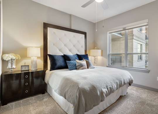 a bedroom with a large bed and a window