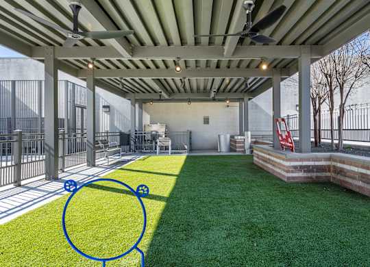 A patio with a green lawn and a blue circle drawn on it.