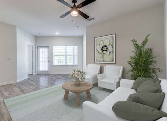 an open living room with white furniture and a ceiling fan