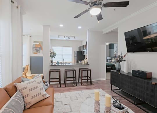 a living room with a couch and a ceiling fan